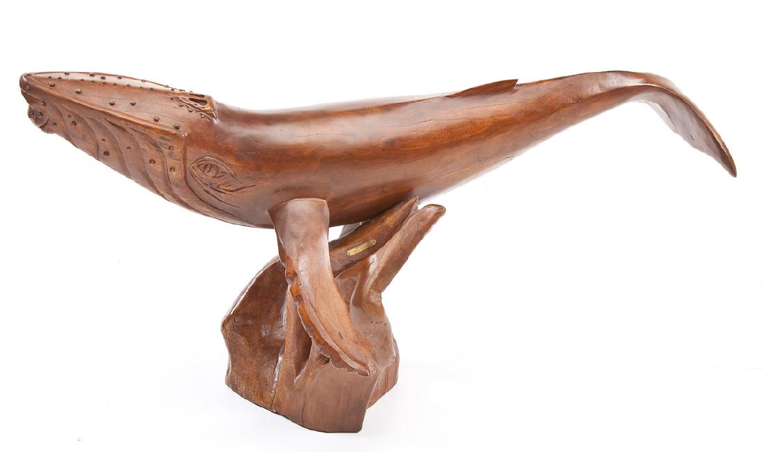 Isaac Tamada (20th Century) 60" Sculpture of Whale: DESCRIPTION: Isaac Tamada (20th century). Large carved wood sculpture of a humpback whale on a carved coral-form base. Base with plaque "Handcrafted by Isaac Tamada". MEASUREMENTS: 60" long x approxim