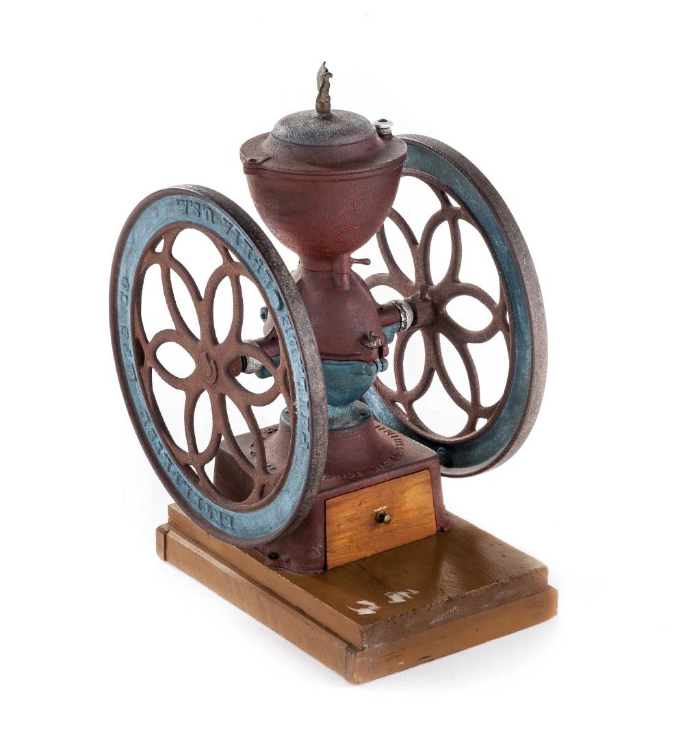Enterprise Countertop Coffee Mill No. 7: DESCRIPTION: Cast iron Enterprise Manufacturing countertop coffee mill model number 7. In red and blue polychrome with eagle finial. Swing lid with porcelain knob and tightening key to right wheel. Ma