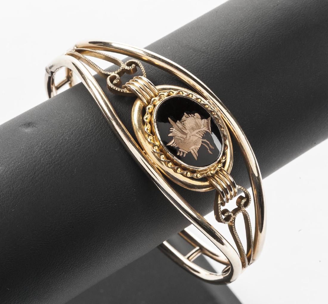Gold Filled Intaglio Bangle: Gold filled openwork bangle bracelet with intaglio to top. 2-1/4" x 2".