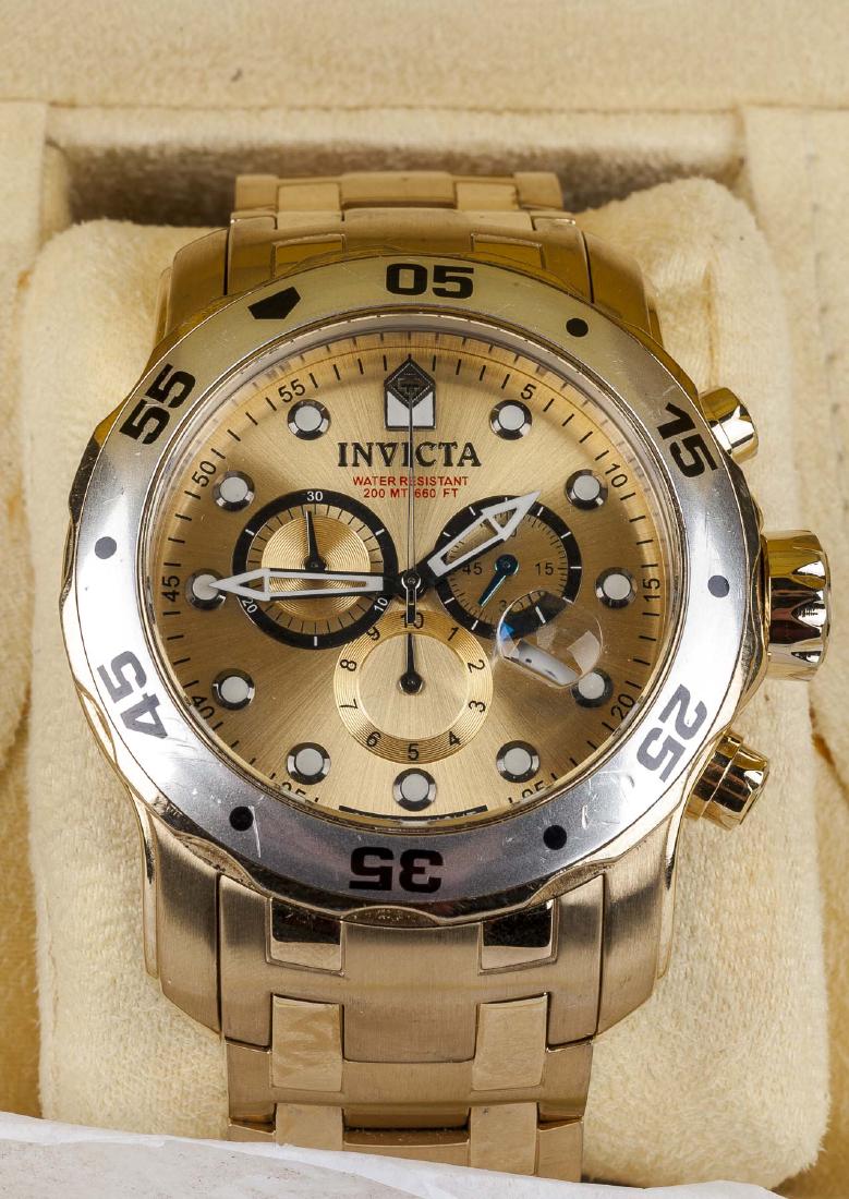 Invicta Pro Diver Chronograph: Model 0074, water resistant to 200 MT / 660 FT. Gold tone face. 2-1/4" lug to lug. In original box with paperwork.