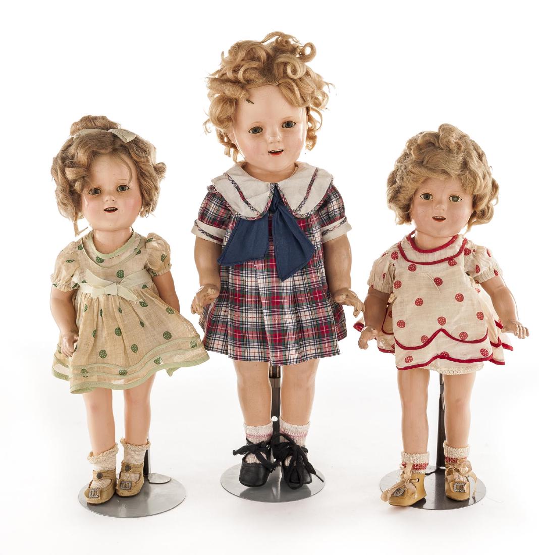 3 Shirley Temple Composition Dolls: DESCRIPTION: Three Ideal Shirley Temple composition dolls. Composition socket head with five-piece jointed body. Sleepy eyes with applied lashes. Open mouth with upper teeth. Each with dress, undergar