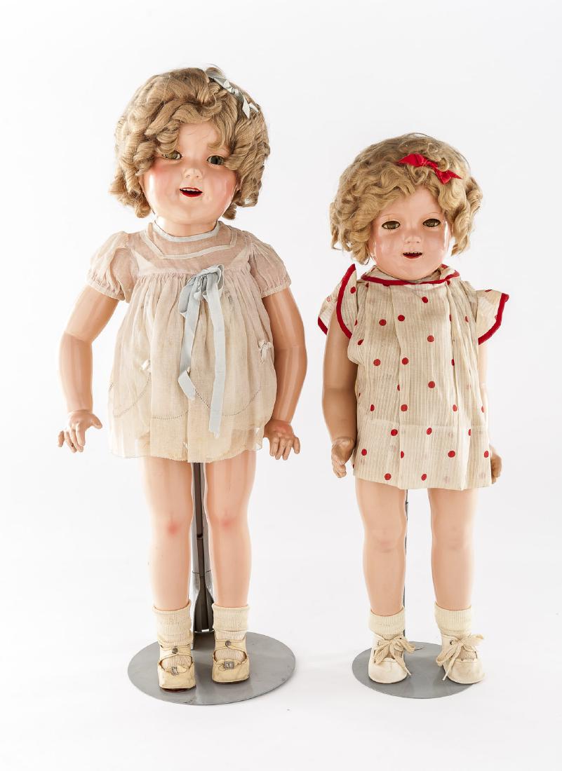 25" & 27" Shirley Temple Composition Ideal Dolls: DESCRIPTION: Two Ideal Shirley Temple dolls. Includes a 25" and a 27" doll. Each with composition body with jointed limbs. Flirty eyes with applied lashes. Open mouths with upper teeth. Dolls are wear