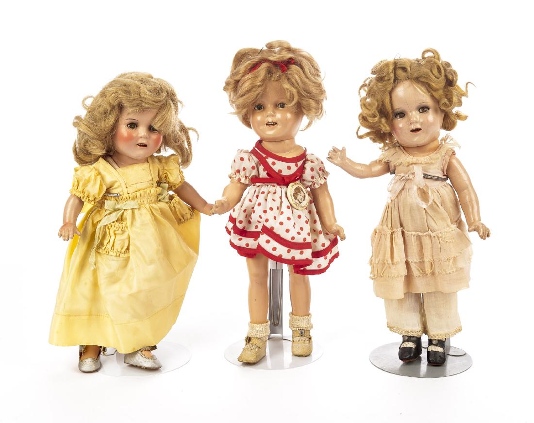 3 Shirley Temple Composition Dolls: DESCRIPTION: Three Ideal Shirley Temple composition dolls. Composition socket head with five-piece jointed body. One with sleepy eyes. Two with flirty eyes. All with applied lashes. Open mouth with up