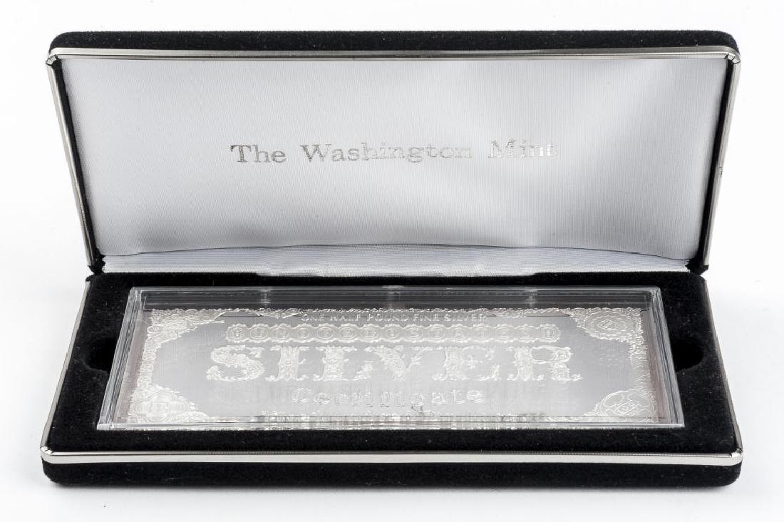 Washington Mint 1996 Half Pound .999 Silver Bar: DESCRIPTION: The Washington Mint 1996 .999 fine silver $500 silver certificate bar. MEASUREMENTS: 8 ozt. Box 7-1/2" x 3-1/2". CONDITION: Tarnishing to edges. In original case and sleeve with certifica