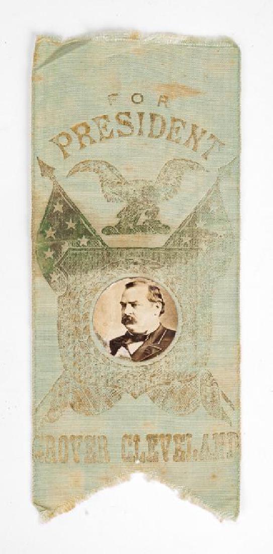 Grover Cleveland Campaign Ribbon with Photo: DESCRIPTION: Political 1884 Grover Cleveland silk campaign ribbon with albumen photo. MEASUREMENTS: 2-1/2" x 5-3/4". CONDITION: Ribbon faded with spots of discoloration. Small pin hole to bottom. Toni