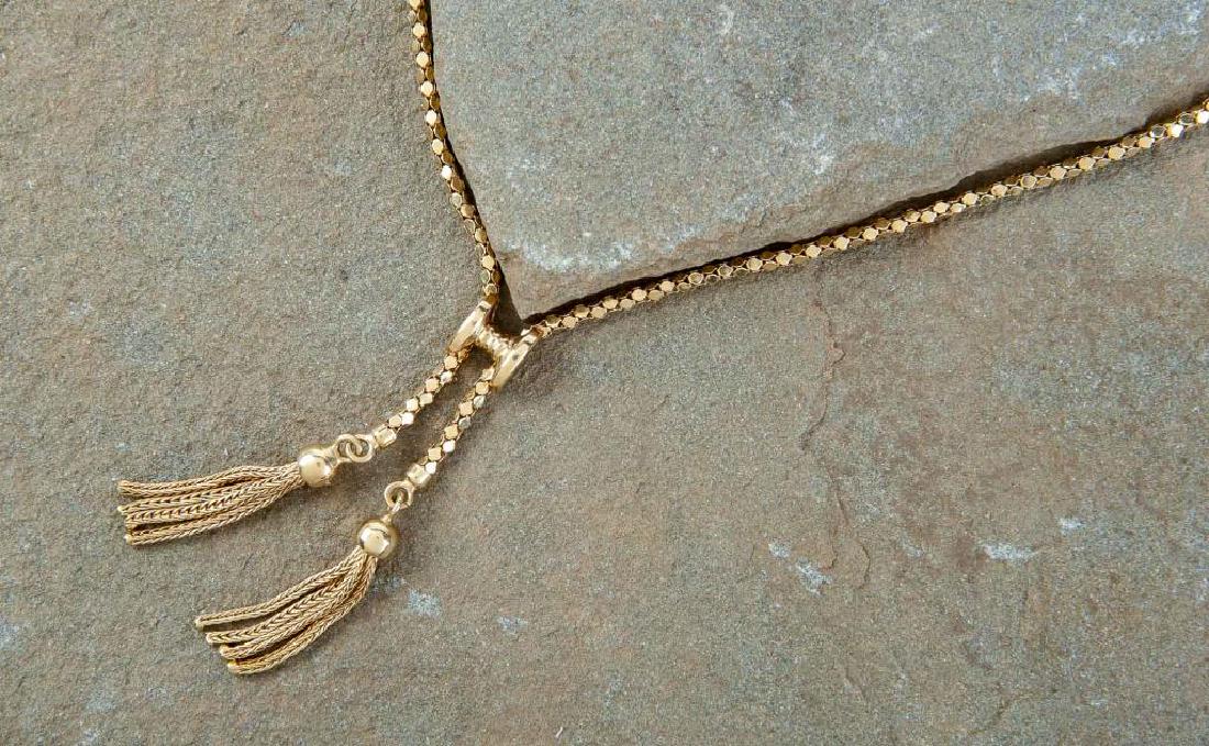 18K Tassel Necklace: DESCRIPTION: 18k tassel necklace stamped 750. MEASUREMENTS: 7.9 dwt (12.3 grams). 18" long. Tassels 2-1/4". CONDITION: No defects noted.