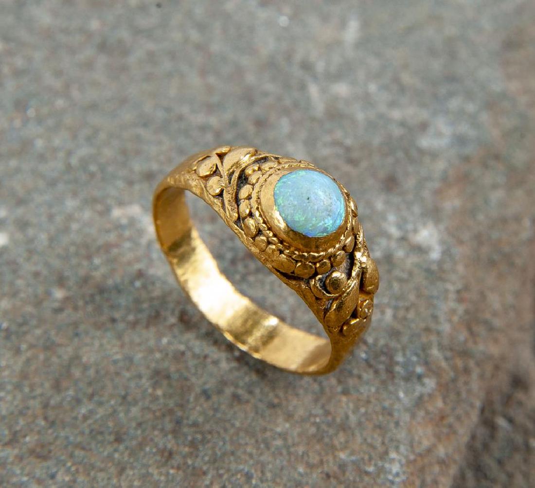 22K Opal Ring: DESCRIPTION: 22k tested ring with opal to center and antiquing to side, Asian symbols to interior of band. MEASUREMENTS: 1.9 dwt (3 gr). Size 3.25. CONDITION: Very light wear.