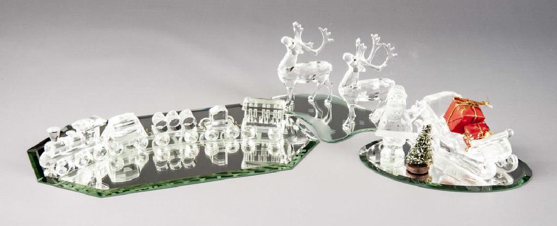 5 Swarovski Christmas Themed Crystals: DESCRIPTION: Five Swarovski Christmas themed crystals each with mirrored base.. Includes 221362 Santa Claus, 205165 Sleigh with two wrapped present and tree, two 214821 Reindeer and When We Were Young