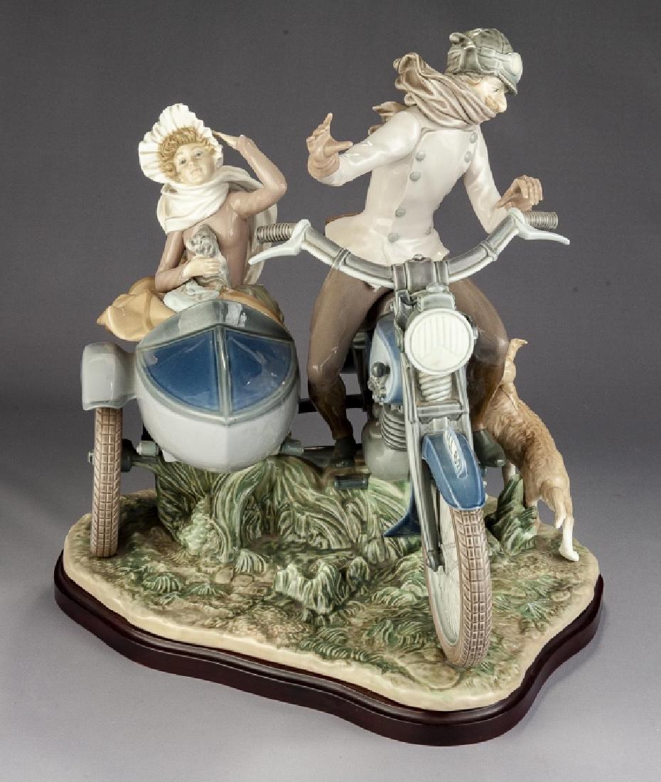 Lladro #5161 'Old Fashion Motorist' Figurine: DESCRIPTION: Lladro #5161 'Old Fashion Motorist' figurine. Glazed finish. On wood base. MEASUREMENTS: 16" x 13" x 14". CONDITION: No defects noted.