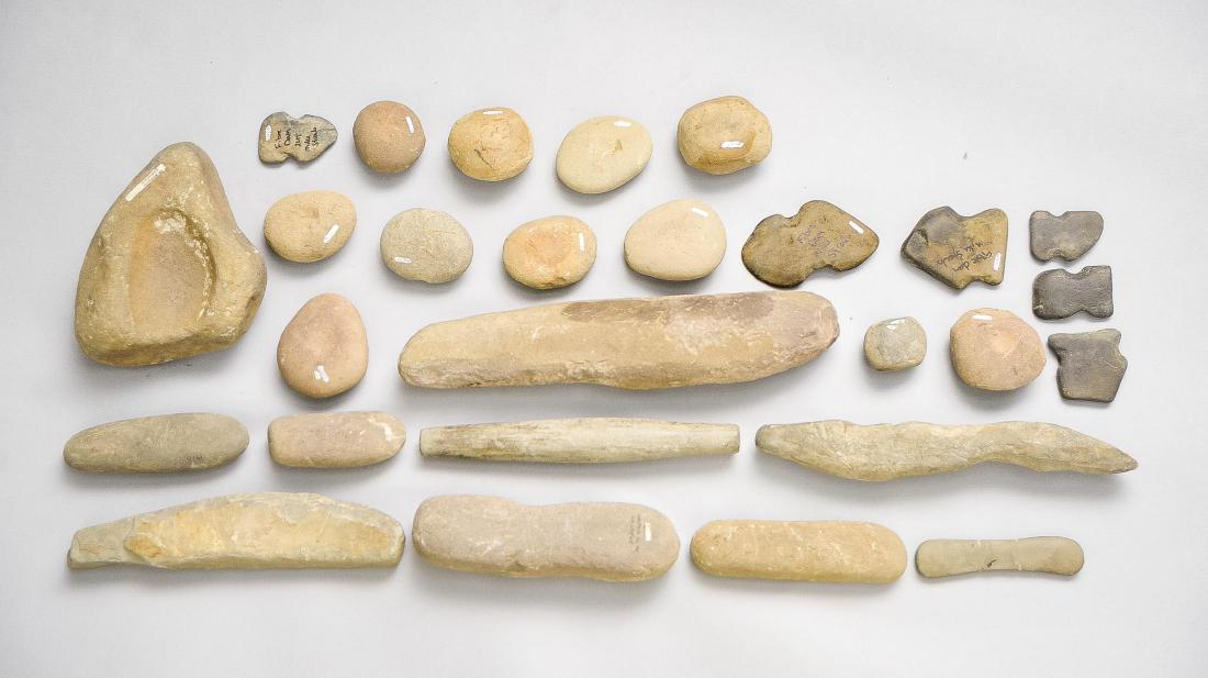 25 Native American Ground Stone Tools: DESCRIPTION: 25 Native American ground stone tools including gorgets, nutting stones, and metates collected in PA including Shamokin, Snyder Collection, Fiere Dam, more. MEASUREMENTS: 2-1/2" to 17".