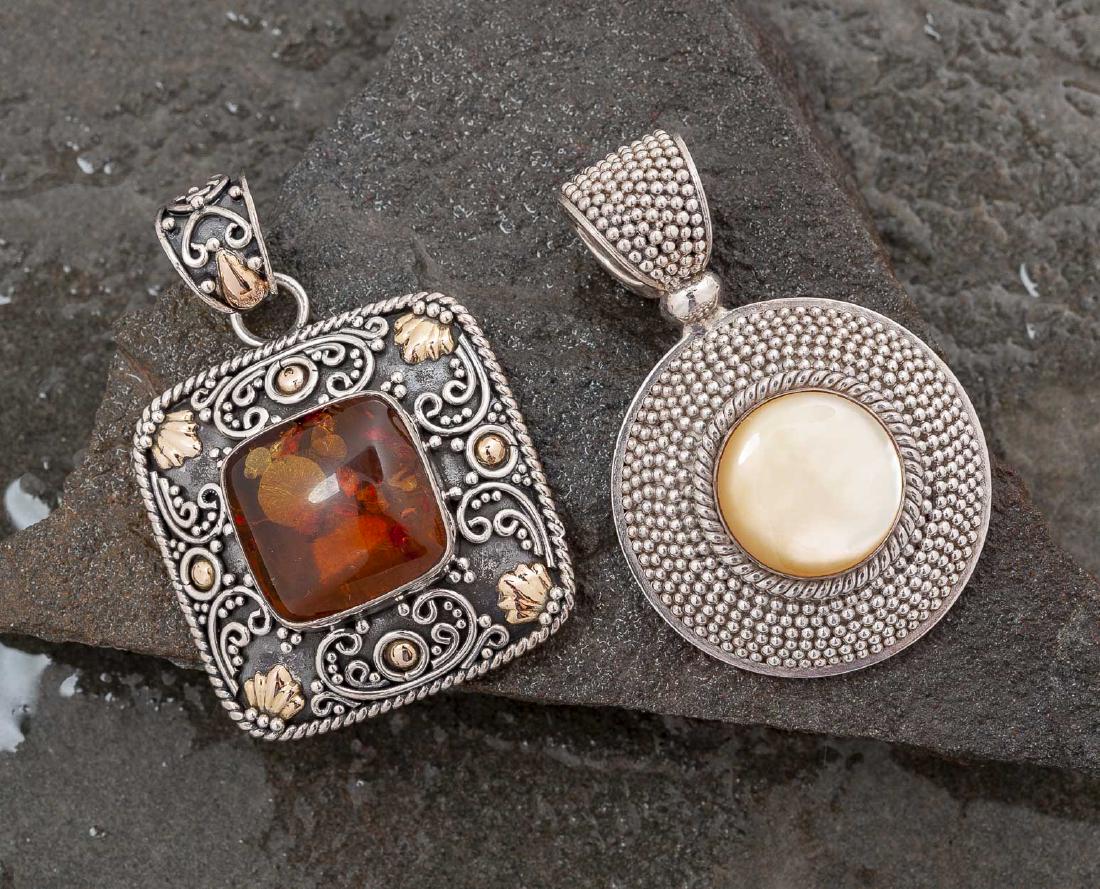 2 Sterling Pendants: DESCRIPTION: Two sterling pendants stamped 925 Indonesia. Square with amber inset and 18k gold detail. Round with mother of pearl. MEASUREMENTS: 1-1/2" x 2" and 1-3/4". CONDITION: Very light wear.