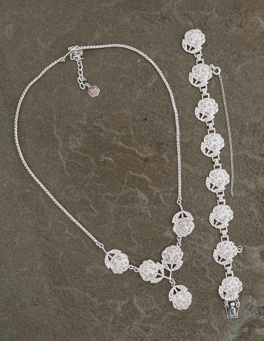 Sterling and Marcasite Flower Set: DESCRIPTION: Sterling and marcasite flower set. MEASUREMENTS: Necklace 14" long, bracelet 7" long by 5/8" wide. Earrings 1-1/4". 1.8 ozt. CONDITION: No defects noted.