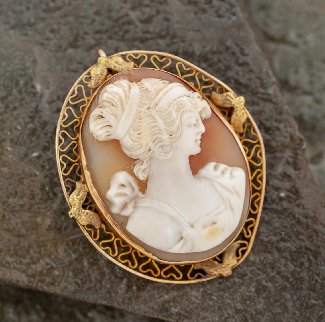 14K Cameo Pendant: DESCRIPTION: Shell cameo pendant/brooch in 14K filigree frame. MEASUREMENTS: 1-1/2" x 2". CONDITION: Very light wear.
