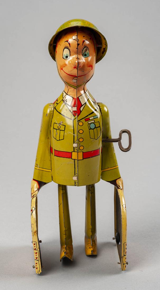 G.I. Joe & His K-9 Pups Wind Up Tin Toy: DESCRIPTION: G.I. Joe and his K-9 pups tin litho wind up toy. Manufactured by Unique Art Manufacturing Co, Inc. MEASUREMENTS: 8-3/4". CONDITION: Minor scratching. Works.