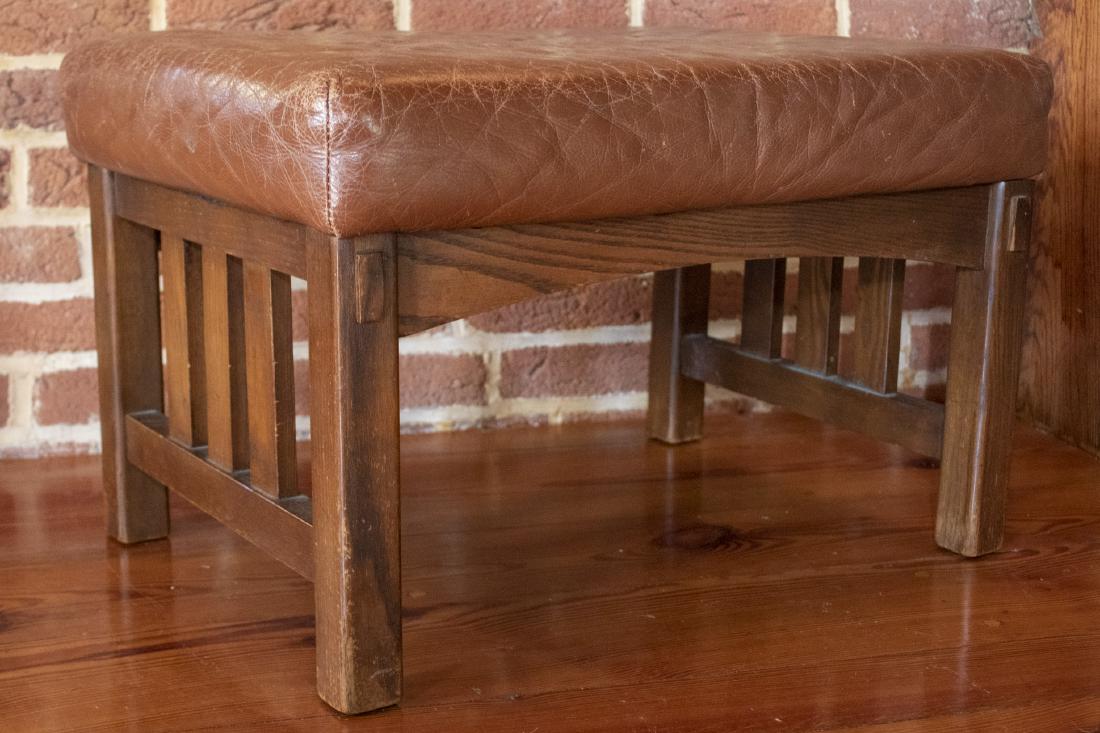 Leather Ottoman: DESCRIPTION: Arts and Crafts Stickley style ottoman with leather upholstery by Sam Moore Furniture. MEASUREMENTS: 18-1/2" x 25" x 16".