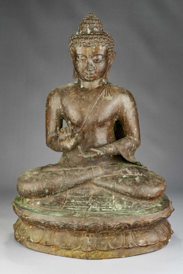 Large Bronze Seated Buddha: DESCRIPTION: Large seated Buddha meditating upon a lotus blossom base. Hair in traditional topknot with elongated ears and triple chin. MEASUREMENTS: 17" wide x 12" deep x 23" high. CONDITION: Overall