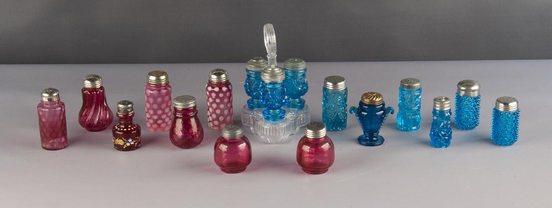 17 Victorian Art Glass Salt & Pepper Shakers: DESCRIPTION: Seventeen Victorian art glass salt and pepper shakers. Includes blue, pink and cranberry glass. One set of blue salt, pepper and toothpick holder on clear glass castor. MEASUREMENTS: Vari