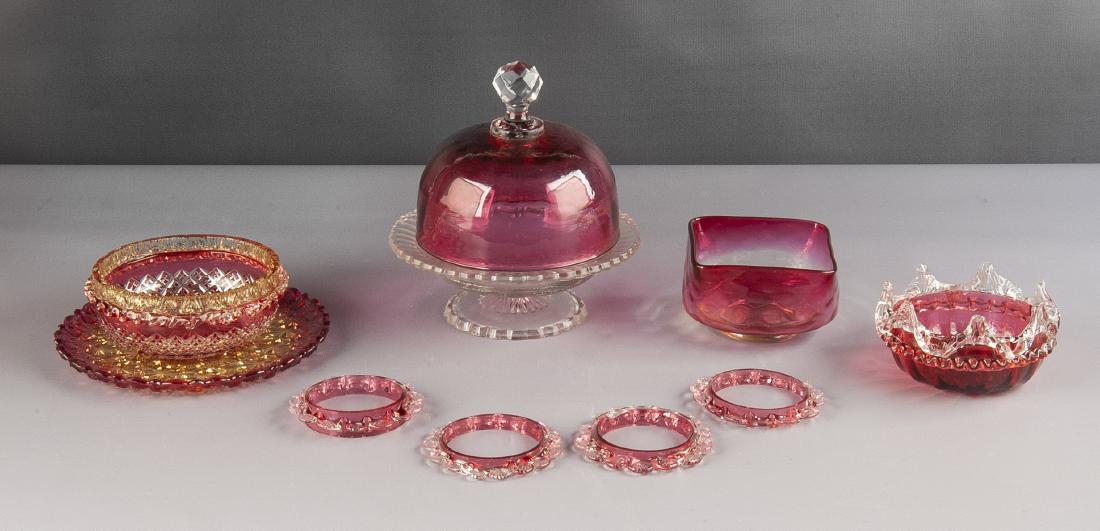 9 Pcs Victorian Cranberry Art Glass: DESCRIPTION: Nine pieces Victorian cranberry art glass. Includes four 3-1/4" rings, 2-1/2" cranberry to amber finger bowl, 7" cran-amber plate, 2-1/2" cran-amber cut glass rimmed ringer bowl, 7" clear