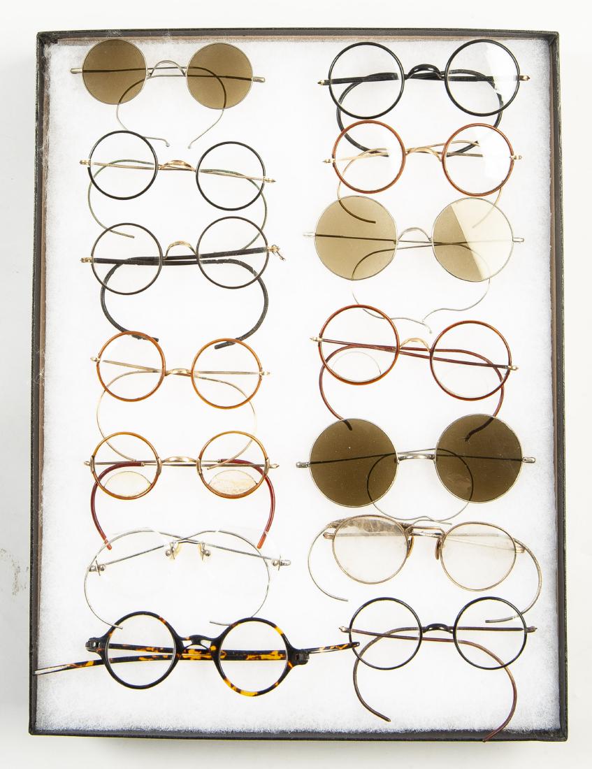 14 Pairs of Eyeglasses: DESCRIPTION: Fourteen pairs of eyeglasses including frameless, celluloid and tinted. MEASUREMENTS: 4" to 5". CONDITION: In riker case.