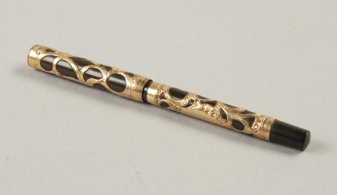Waterman Gold Filigree Fountain Pen: DESCRIPTION: Waterman fountain pen. American, early 20th century. Gold-filled late-style filigree over black. Clip cap. MEASUREMENTS: 5-1/2" long. CONDITION: Wear to filigree. Losses to clip on cap. N