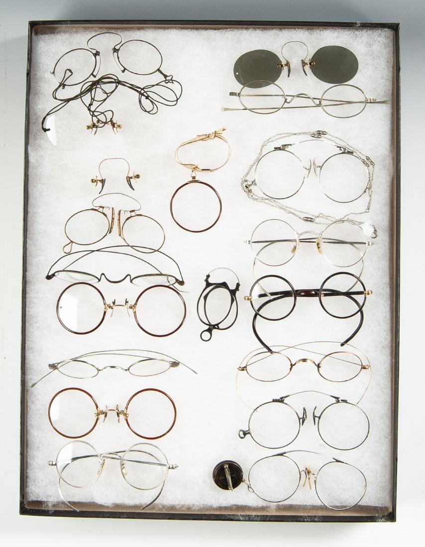 18 Pairs Eyeglasses: DESCRIPTION: Eighteen pairs of eyeglasses including Pence-Ney, lorgnettes, and one monacle. MEASUREMENTS: Monacle 1-5/8" diameter, others 4" each. CONDITION: In riker case.