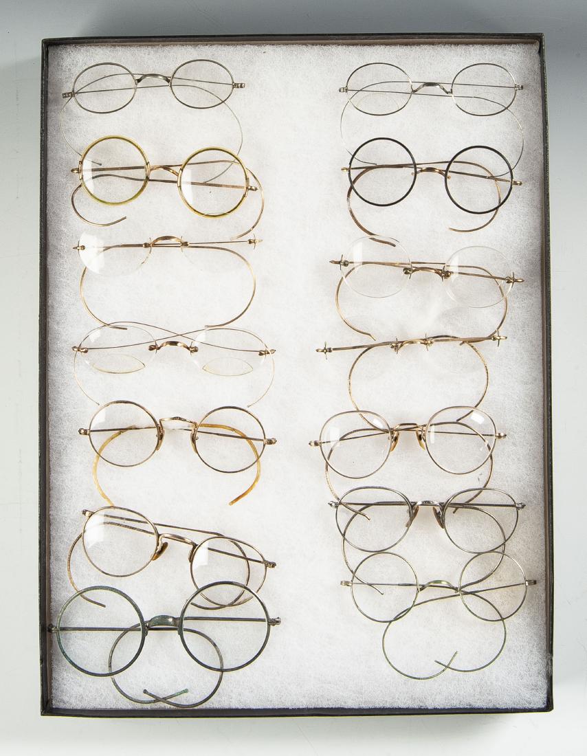 14 Pairs Eyeglasses: DESCRIPTION: Fourteen pairs of eyeglasses including goldfilled, celluloid and frameless. MEASUREMENTS: 4" to 5". CONDITION: In riker case.