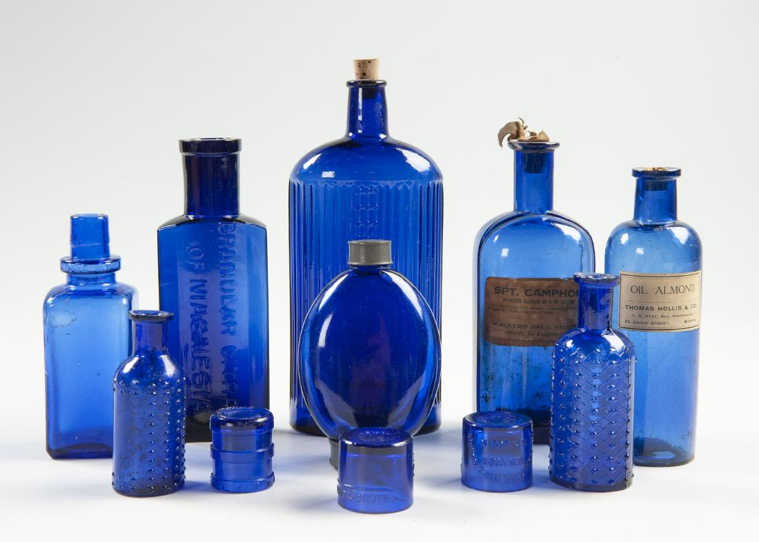 11 Cobalt Apothecary Items: DESCRIPTION: Eleven cobalt glass apothecary items including medicine bottles. MEASUREMENTS: 1-1/2" to 7-3/4". CONDITION: Good. One small bottle with chip.