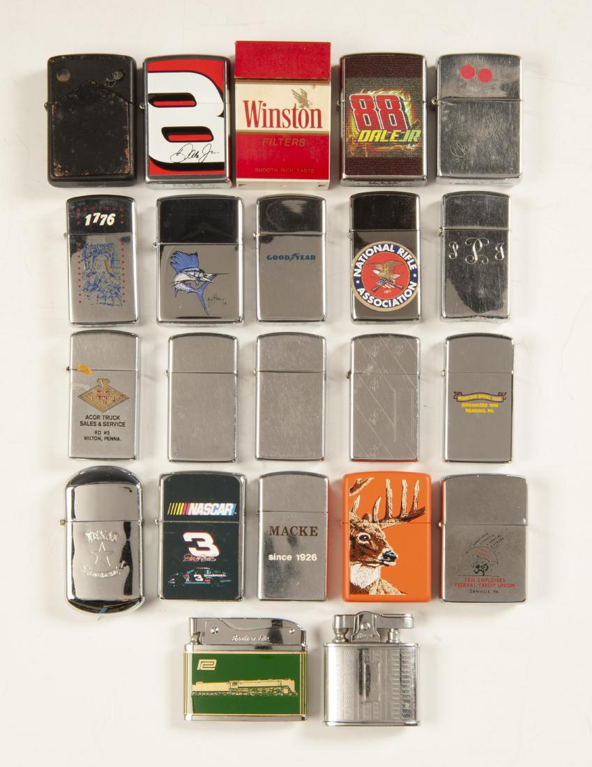 22 Lighters Incl Zippos: DESCRIPTION: Collection of Twenty-two lighters. Includes eighteen Zippo, one Gibson, one Brother-Lit, and two unmarked. Themes includes NASCAR, NRA, hunting, centennial, and advertising. CONDITION: Su