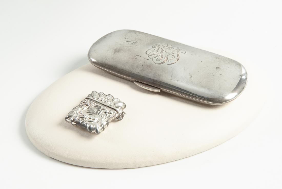 2 Sterling Cases: DESCRIPTION: 1) Sterling green velvet lined eye glasses case with monogram, 4-1/2". 2) Sterling stamp case, 1-1/4". MEASUREMENTS: 2.3 ozt. See Description. CONDITION: Light wear.