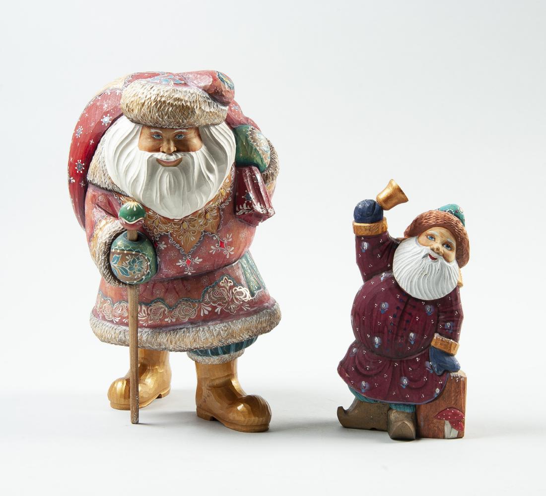 2 Hand Carved & Painted Russian Santa Figurines: DESCRIPTION: Two hand carved and painted Russian Santa Claus figurines. Includes 8-1/2" Santa figure ringing bell and 12" Santa with large sack with winter landscape scene painted on back. MEASUREMENT