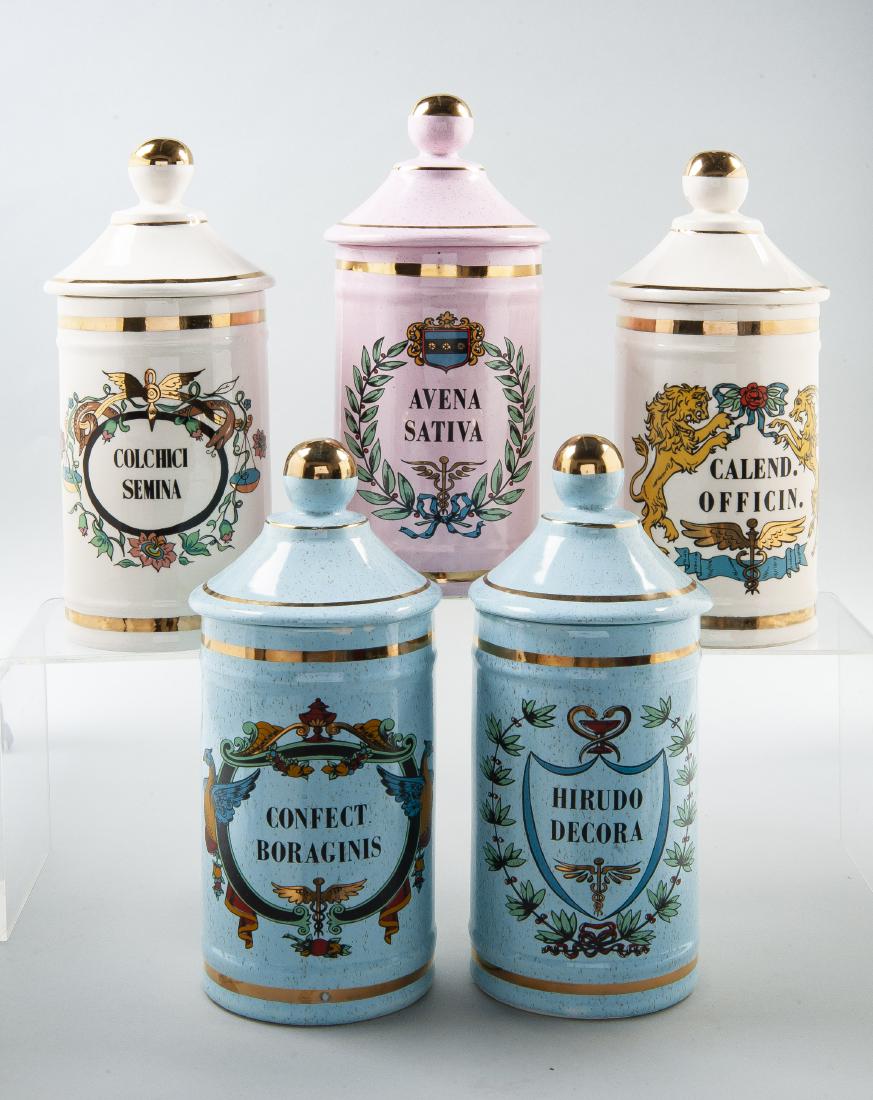 5 Drug Store Ceramic Apothecary Jars: DESCRIPTION: Five drug store ceramic apothecary jars with lids. Includes blue confect borgainis jar, blue hirudo decora jar, cream calend. officin. jar, cream colchici semina jar, and pink avena sativ