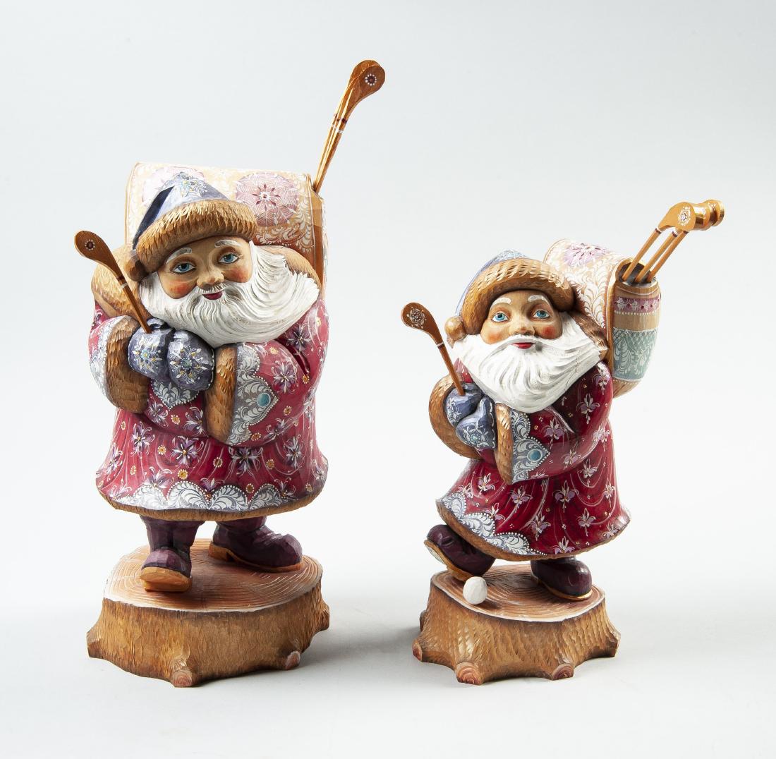 2 Hand Carved & Painted Russian Santa Figurines: DESCRIPTION: Two hand carved and painted Russian Santa Claus figurines. Includes large 13-1/2" Santa golfing figure with pack and four removable golf clubs and small 11-1/2" Santa golfing figure with 