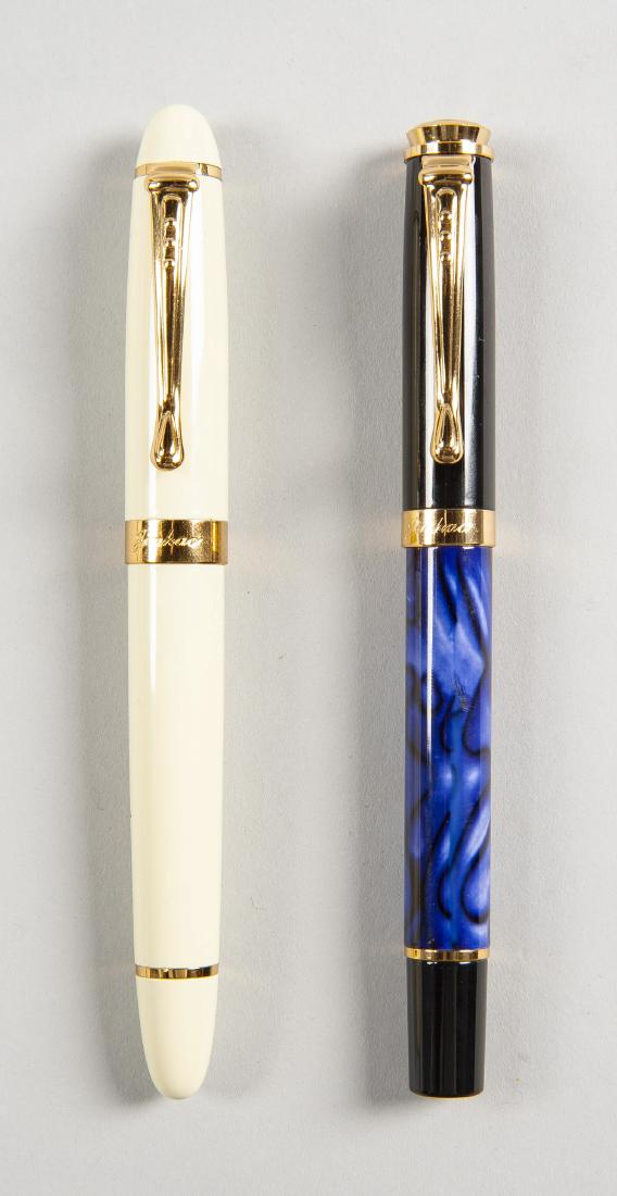 2 Jinhao Fountain Pens: DESCRIPTION: Two Jinhao fountain pens. Includes: 1) Jinhao X450 with cream colored resin case. 18k gold nib. 2) Jinhao 500 with blue and black marbled resin case. 18k gold nib. MEASUREMENTS: Both 5-1/