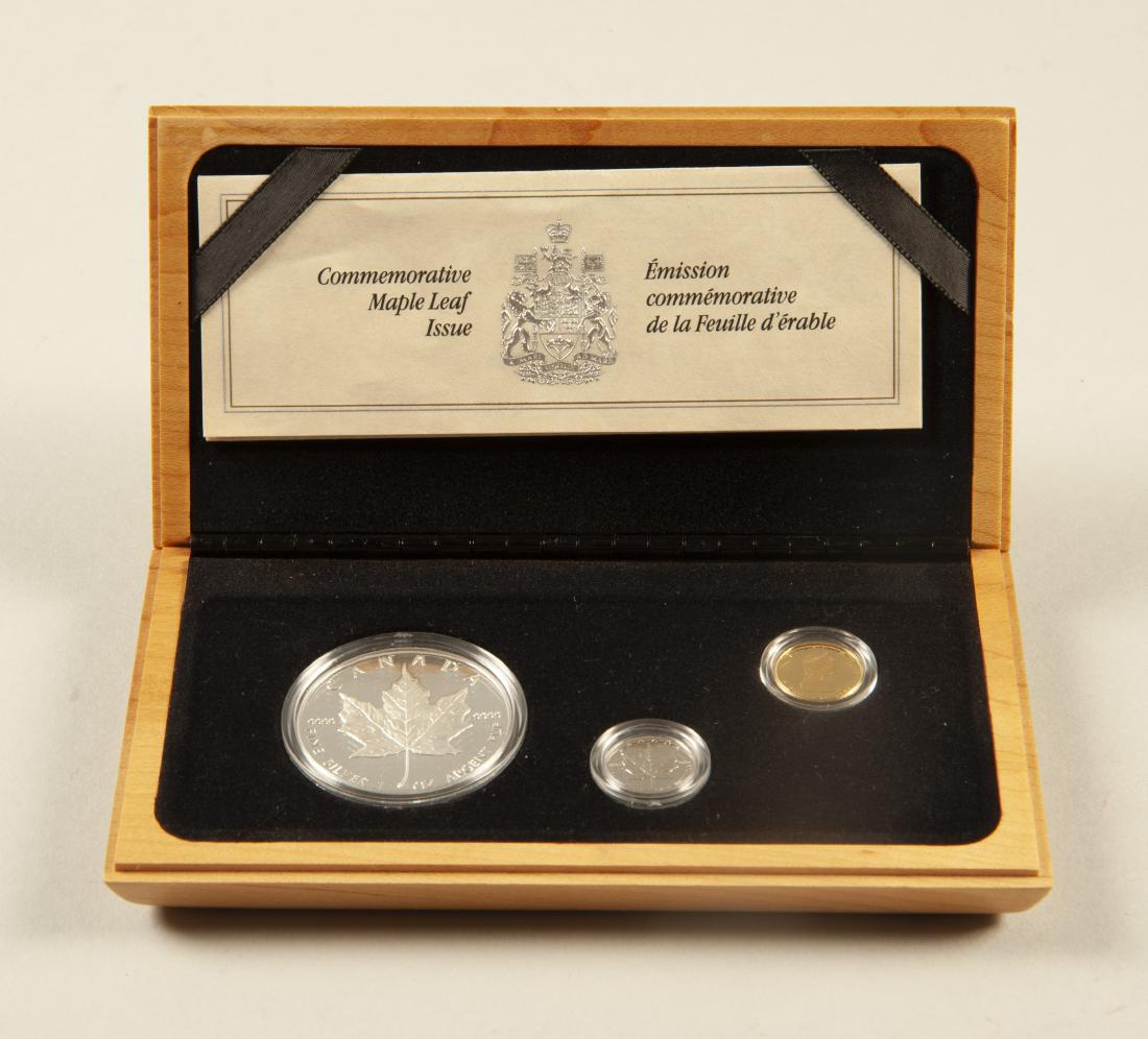 1989 Commemorative Maple Leaf Issue Coin Set: DESCRIPTION: 1989 Royal Canadian Mint comm Maple Leaf issue three coin set. In wood case. COA.