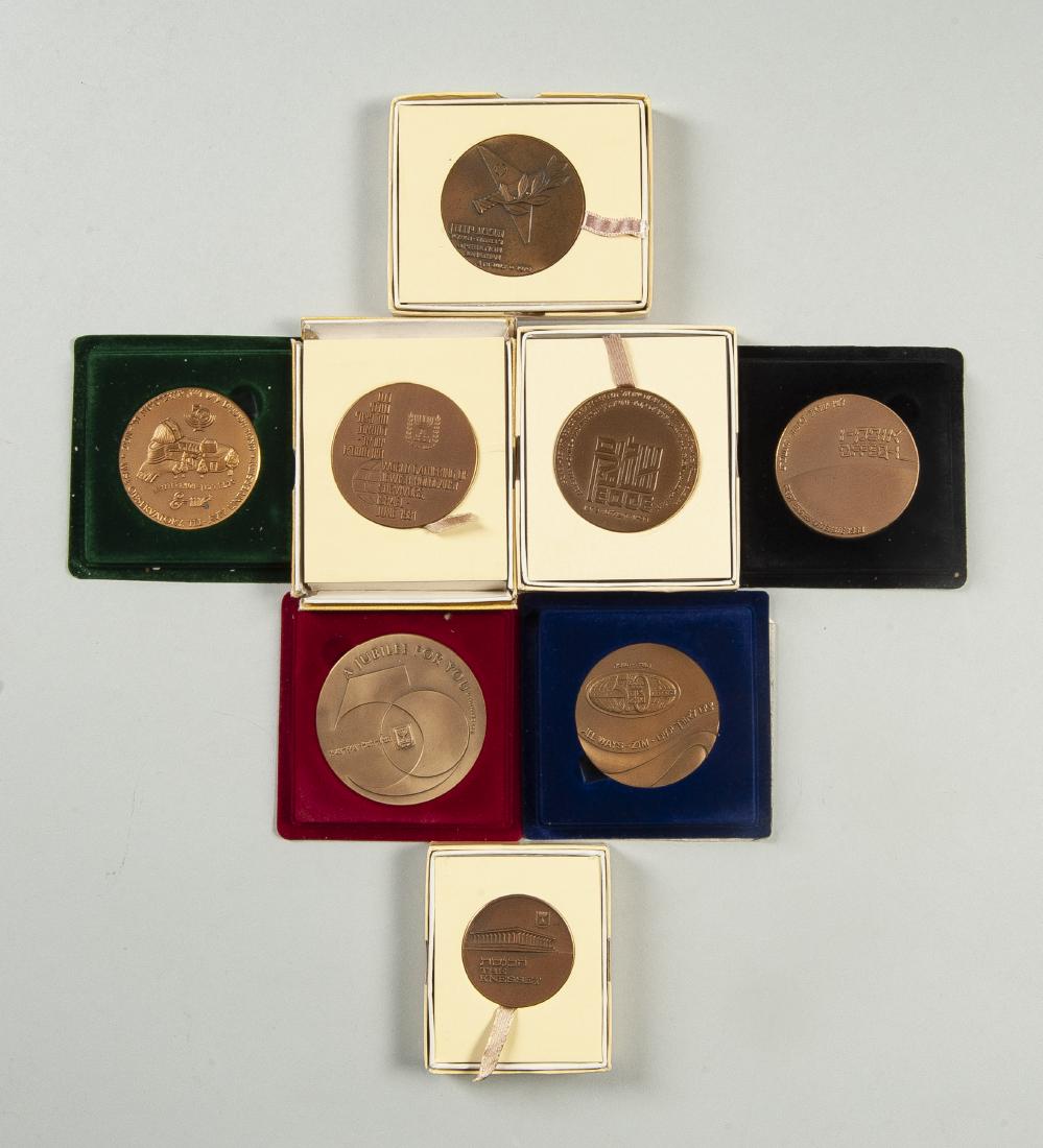 8 Israeli Commemorative Bronze Medallions: DESCRIPTION: Eight Israeli commemorative bronze medallions. Includes: Zim 50th ann. award medal, The Knesset Jerusalem medal, 1976 July 4th Operation Jonathan, 1981 World gathering of Jewish Holocaust