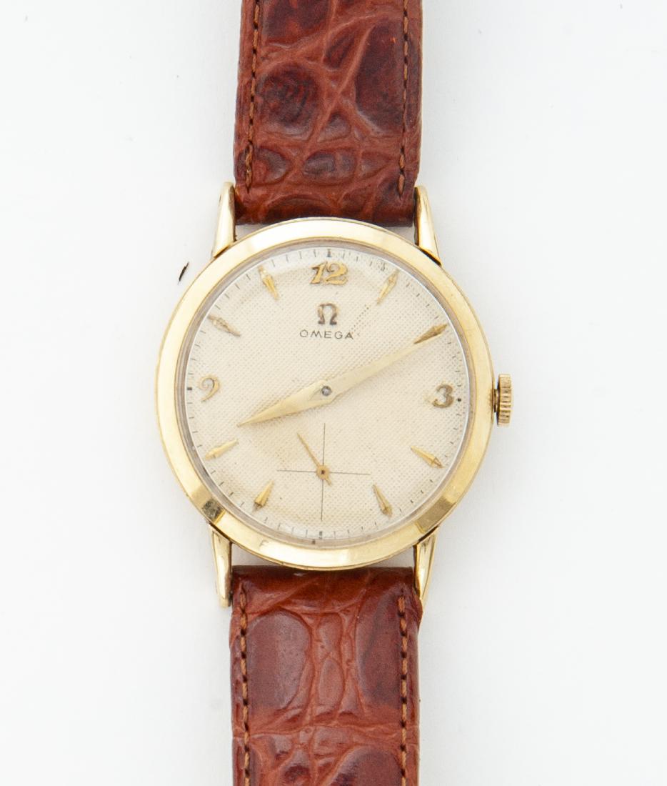 Man's 14K Omega Wristwatch: DESCRIPTION: Man's 14k Omega wristwatch with round 14 karat gold case. Numbers 12, 3, and 9. MEASUREMENTS: Case 1-1/4" diameter. CONDITION: Running. Minor surface scratches to bezel.