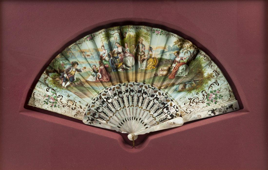 Framed Hand Painted Decorative Folding Fan: DESCRIPTION: Framed hand painted folding fan. Engraved and reticulated mother of pearl sticks, ribs, and guard with gilt and gray accents. Metal closure clasp. Leaves with hand painted pastoral scene 