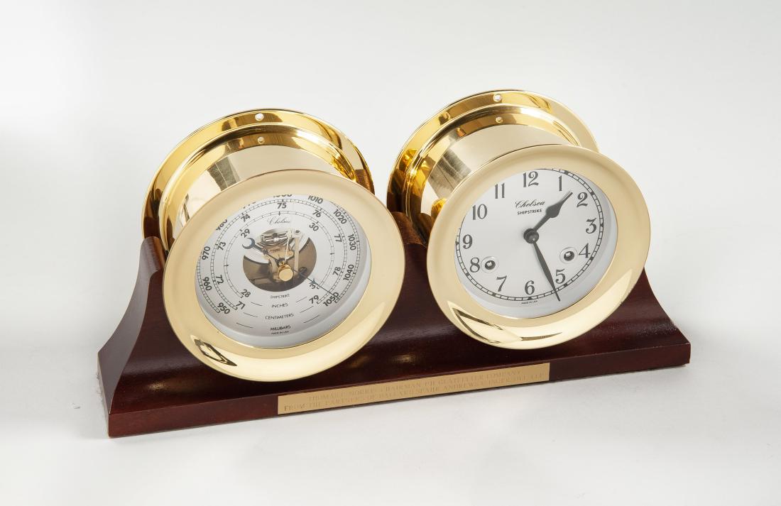 Chelsea Desk Clock Barometer Set: DESCRIPTION: Chelsea shipstrike desk clock barometer set with brass cases and wood base. Plaque on base reads "Thomas C. Norris- Chairman P.H. Glatfelter Company from the Partners of Ballard Spahr And