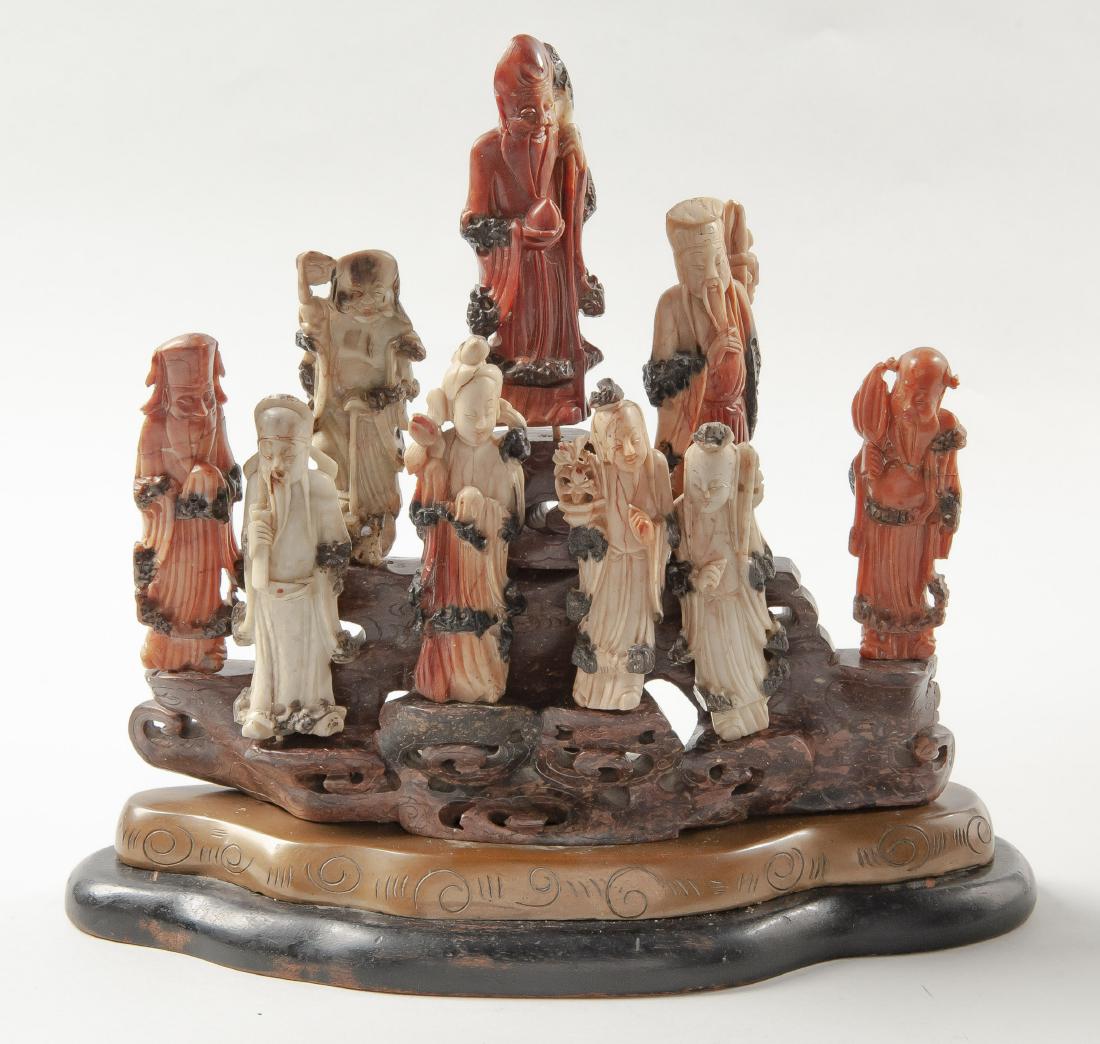 Soap Stone Carvings of 8 Immortals and Shou Lao: DESCRIPTION: Group of nine soap stone carvings of the eight Chinese immortals and Shou Lao. All on a carved hardstone base depicting a mountain. Carving rests upon metal and wood base. Was once mounte