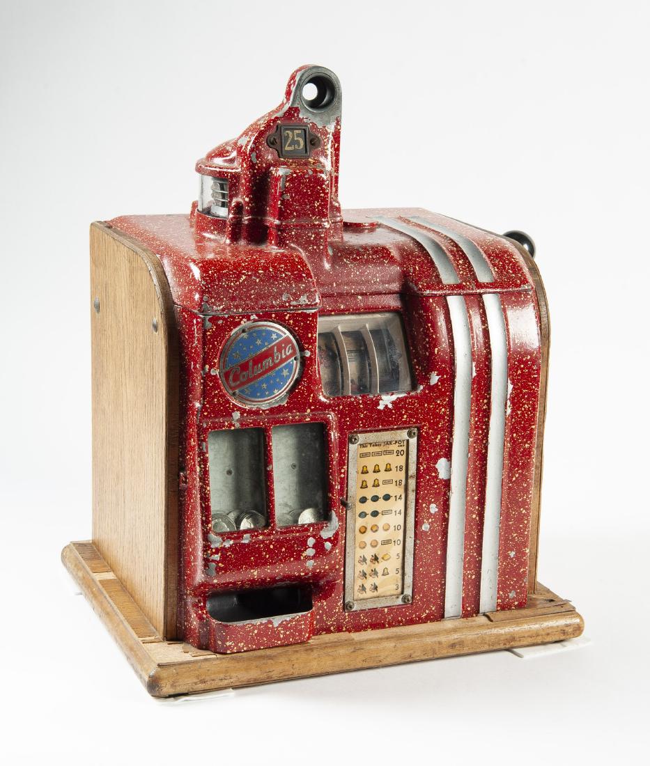 Groetchen Columbia 25 Cent Slot Machine: DESCRIPTION: Groetchen "Columbia" twenty-five cent jackpot bell slot machine. Circa 1940. Aluminum front, oak base and sides. Red speckled paint. Original three fruit reel strips and payout sign. Mech