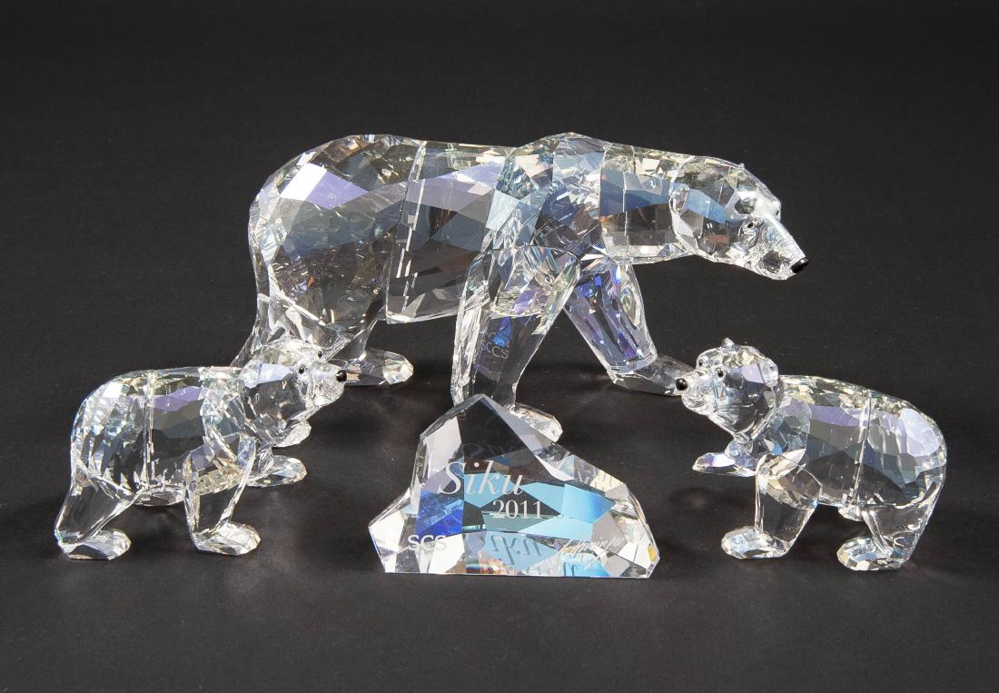 2 Swarovski Polar Bears: DESCRIPTION: Two Swarovski Polar Bears. Incl: 1) Swarovski Crystal Society Polar Bears Cubs Cry Moonlight. 2) Siku 2011 Polar Bear. Both in ob. Siku with plaque and brochure. CONDITION: Excellent. Box