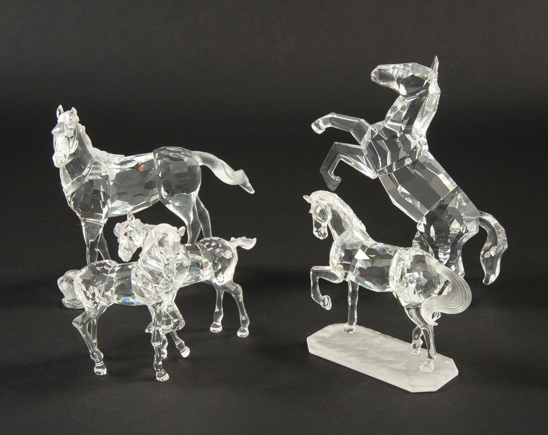 4 Swarovski Horses: DESCRIPTION: Four Swarovski Horses. Includes Arabian Stallion, Foals, Mare, The Horse. Each with ob. CONDITION: Excellent. Shelf wear to boxes.