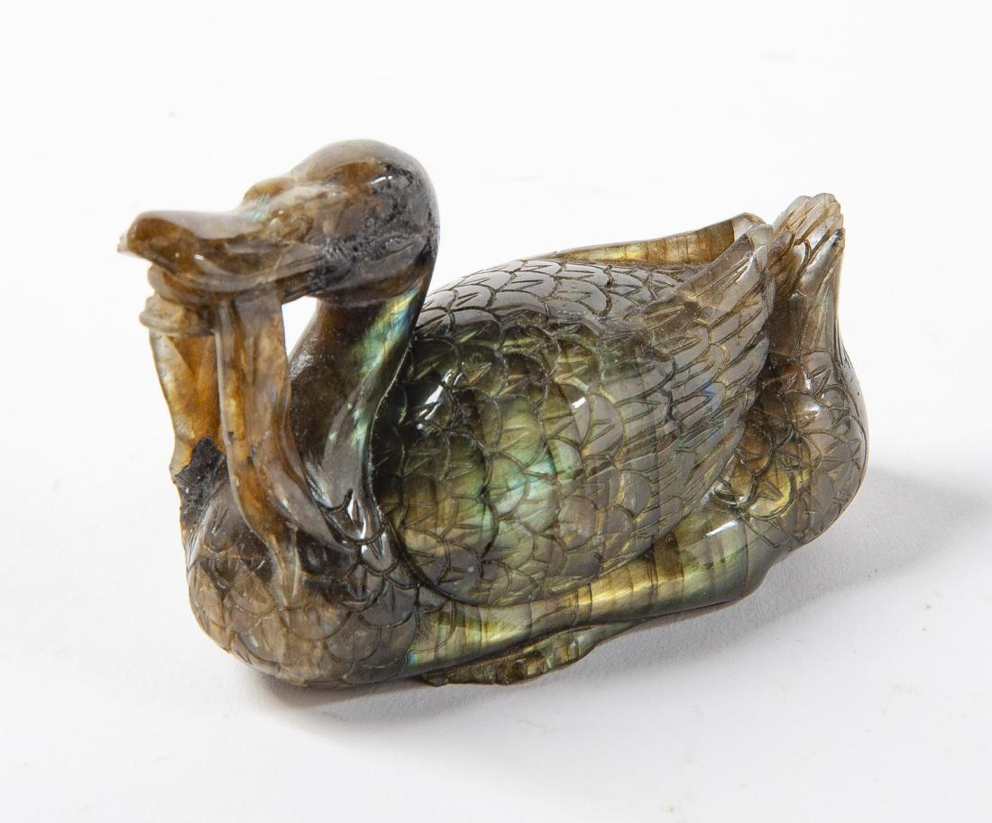 Chinese Carved Labradorite Duck: DESCRIPTION: Chinese carved labradorite figure of a swimming duck with sea vegetables in its mouth. MEASUREMENTS: 4" long x 2" wide x 2-1/4" high. CONDITION: No defects noted.