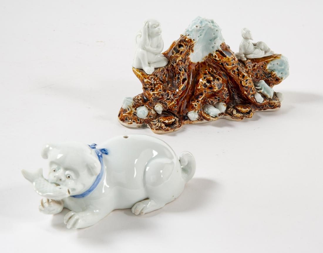 2 Pcs Herado Porcelain Incl Dog & Brush Holder: DESCRIPTION: Two pieces of Herado porcelain. Includes: 1) Dog with fish in its mouth. 7" x 3". 2) Brush holder of monkey, frog, squid, and immortal on a rocky beach. 8" x 5". MEASUREMENTS: See Descrip
