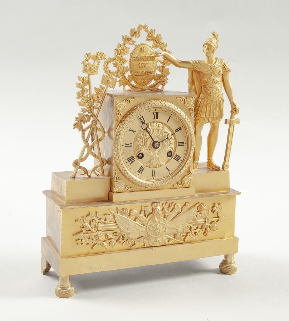 Delaunoy a Paris Ormolu Figural Mantle Clock: DESCRIPTION: French ormolu figural mantle clock. Works signed Delaunoy a Paris. Pendulum driven movement. Dial with Roman numerals and time and strike. Ormolu case with figure of a soldier to the righ