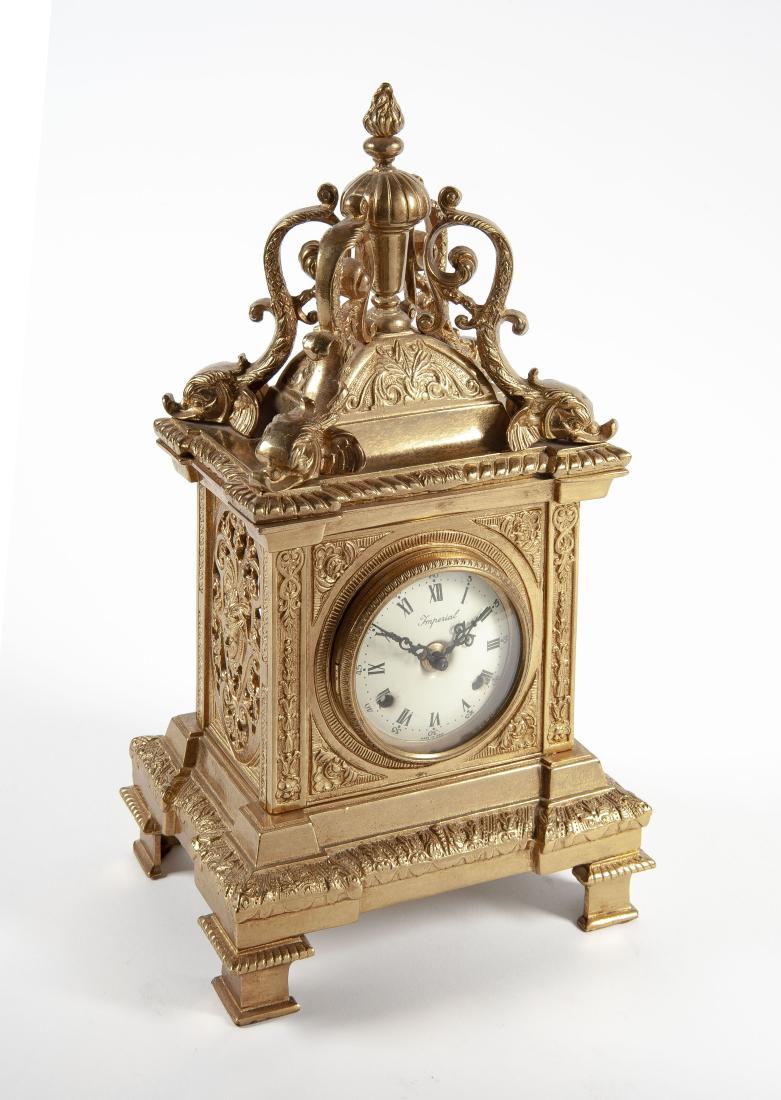 Imperial Bronze Mantle Clock: DESCRIPTION: Imperial bronze mantle clock. Elaborately decorated bronze case surmounted by dolphin and finial. Porcelain dial with Roman numerals and time and strike. Works marked "EHS Germany". MEASU