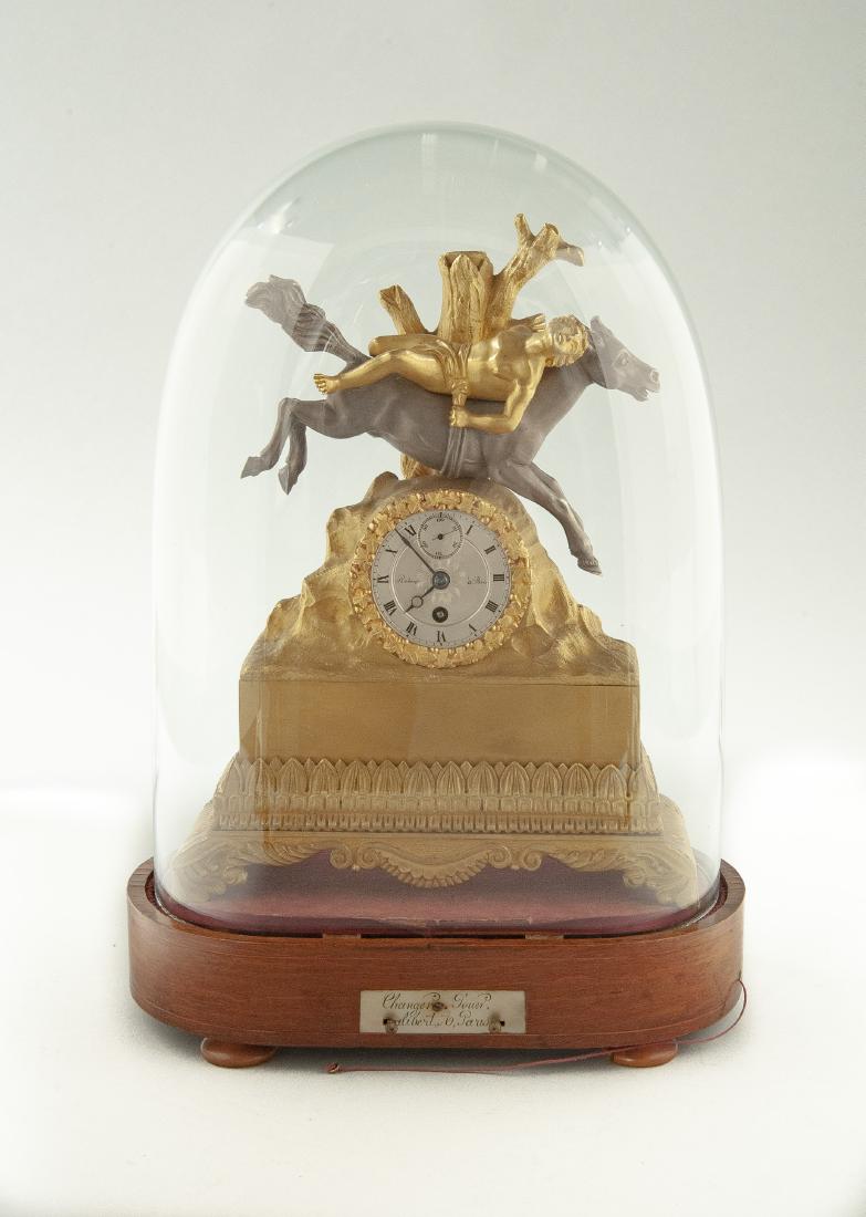 Robert a Paris Parcel Gilt Clock on Musical Base: DESCRIPTION: Henri Robert, Paris parcel gilt mantle clock on musical base. Circa 1800. Gilt bronze case with figure of a mazeppa on a horse. Silvered dial with Roman numerals and subsidiary second han