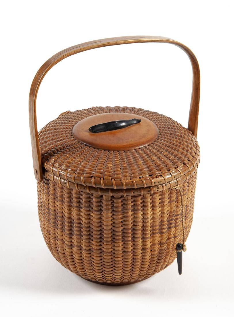 Jose Reyes Signed Nantucket Basket Purse: DESCRIPTION: Jose Formoso Reyes (Philippine/American, 1902-1980) Nantucket basket handbag circa 1960. Wood and rattan round lidded form with whale to top. Bentwood hinged handle. Signed to bottom. MEA