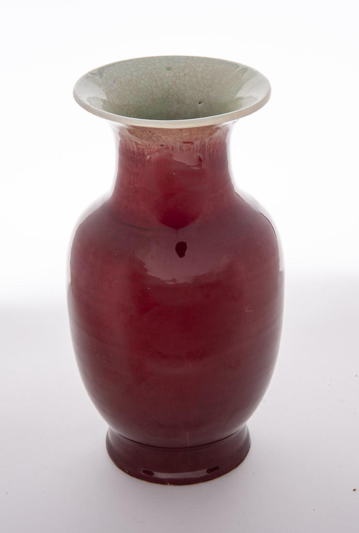 Ox Blood or Flambe Baluster Form Vase: DESCRIPTION: Ox blood or flambe baluster form vase. MEASUREMENTS: 8" x 13". CONDITION: Old restoration to rim. Does not detract. Even overall crazing.
