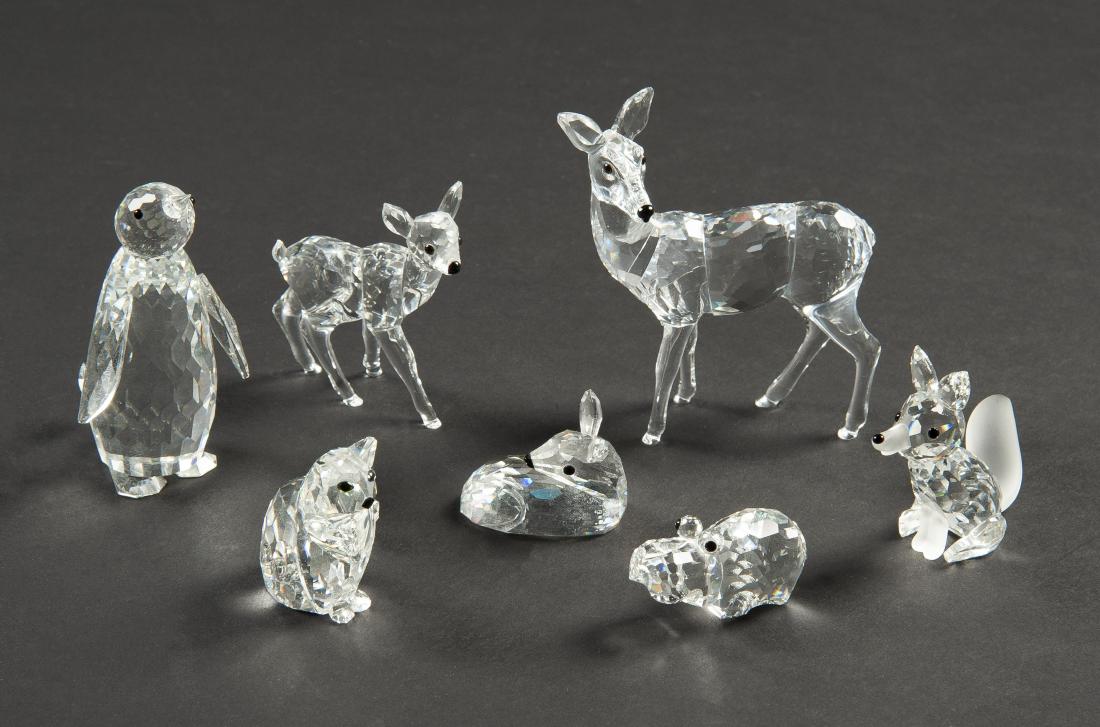 7 Swarovski Animals: DESCRIPTION: 7 Swarovski Animals. Includes doe, fawn, lying fawn, cat, fox, penguin, and baby hippo. Each in ob. MEASURMENTS: Ranges 3/4" to 3-1/4" high. CONDITION: Shelf wear to boxes. Foxes tail det